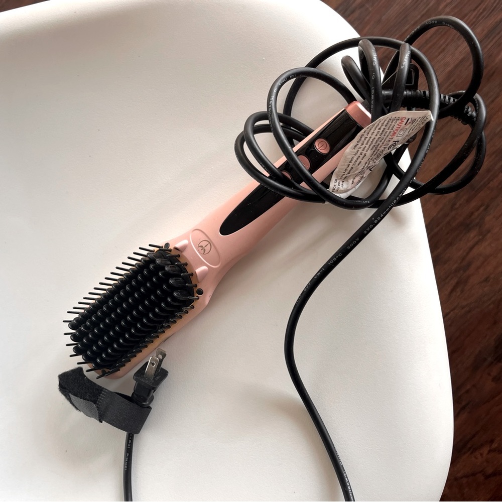l’ange ceramic hair straightening brush. Works amazingly well.
